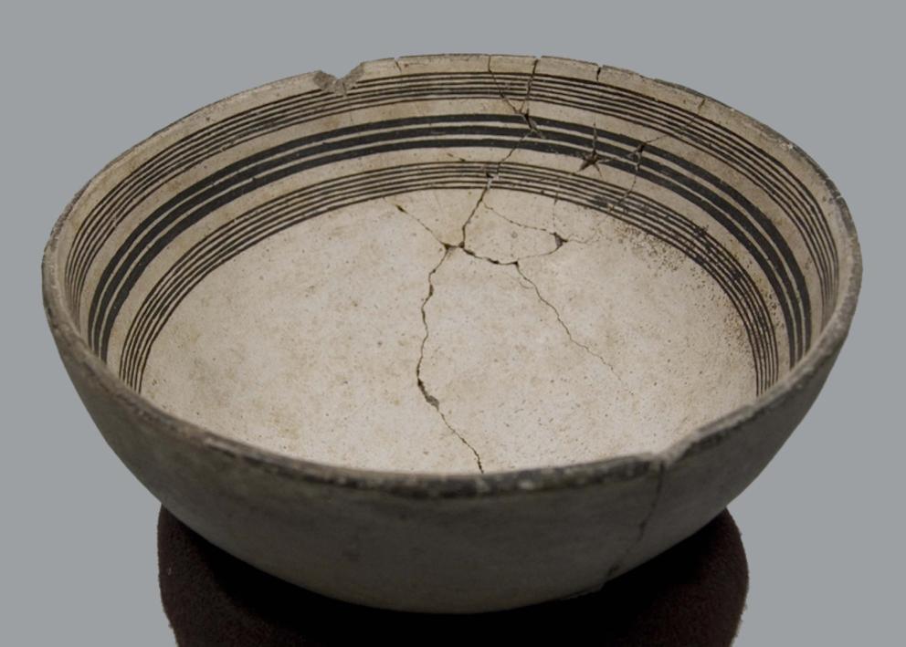 slightly cracked wide-mouthed bowl with lines around the rim