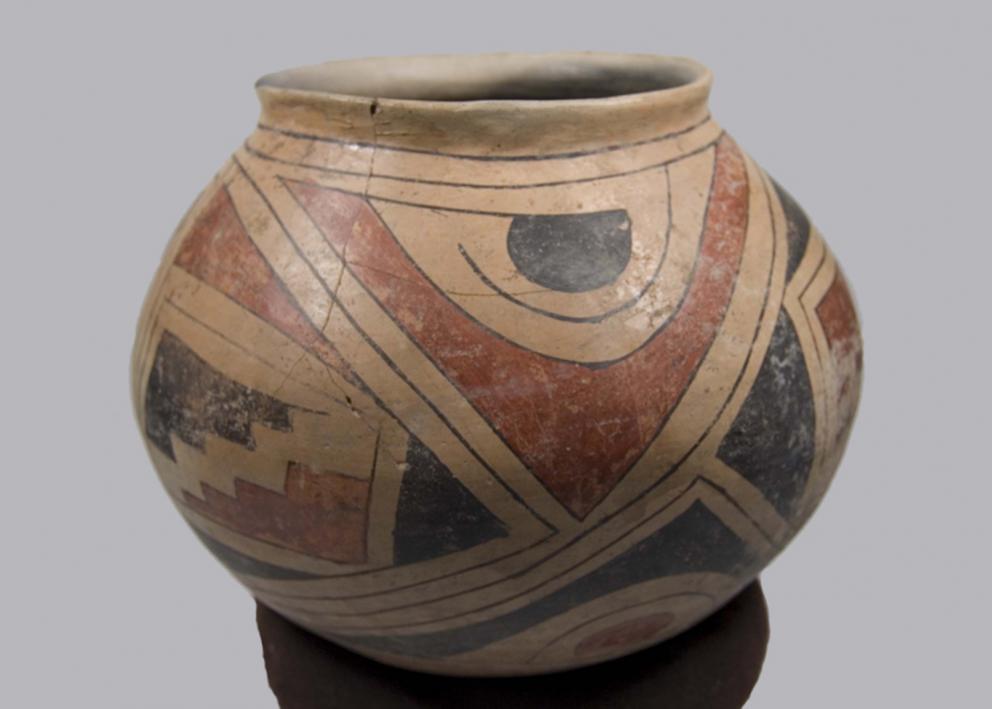  A round pot with a wide opening, with black and red geometric designs over a tan base color
